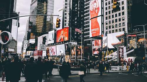 united states group of people walking along the street near buildings theater district